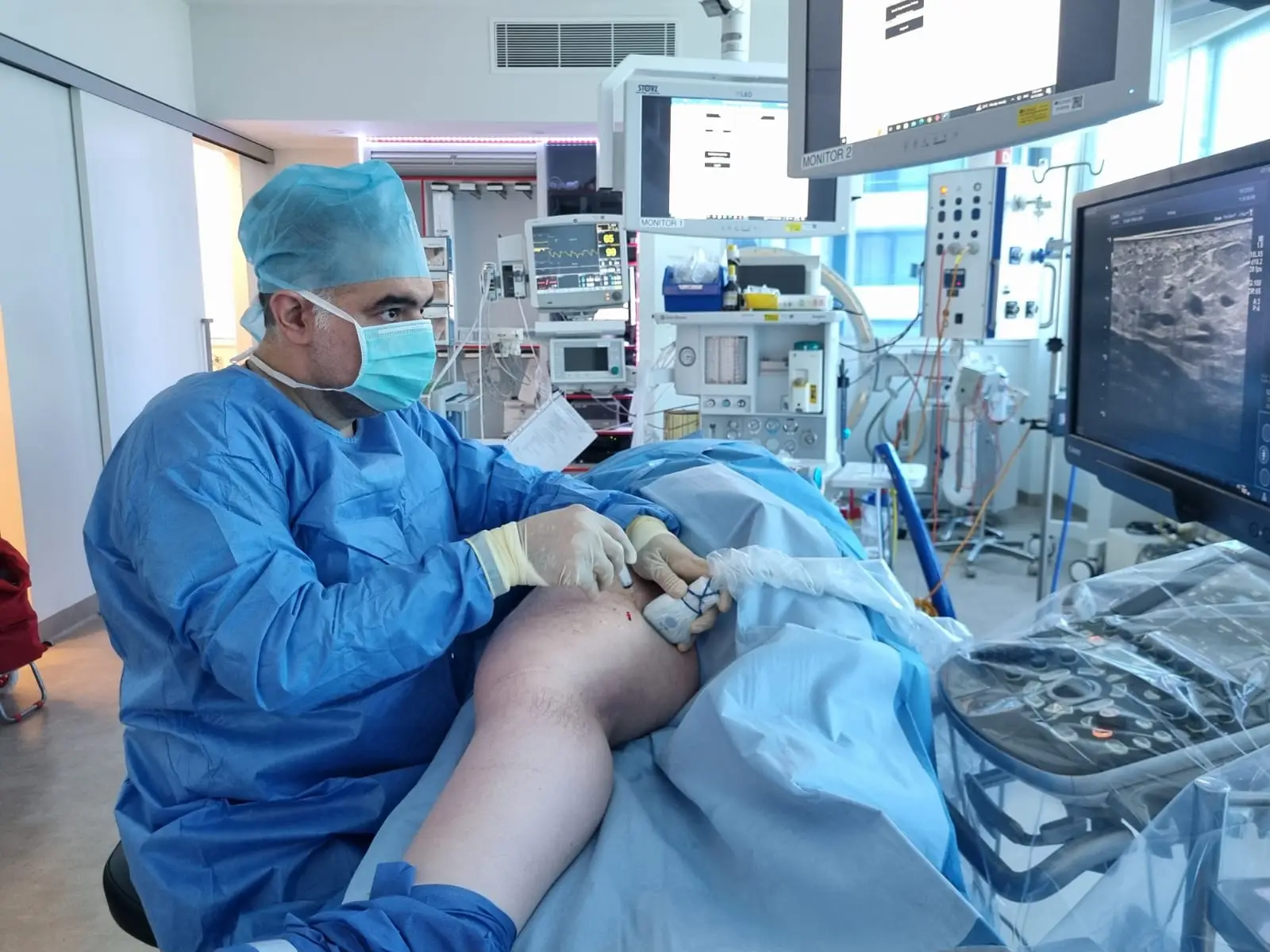 Dr Babak Khanzadi performing ultrasound-guided vascular procedure in Sydney operating room
